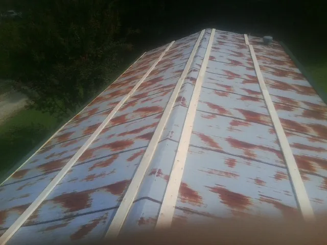 Rusted metal roof panels with new wood purlins before replacement — Storm Damage Roof Repair in Wells River by Roofing Brothers